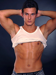 Hot brunette stud posing naked and shows his butt