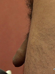 Horny young man entering a swimming pool cubicle to change for a swim.