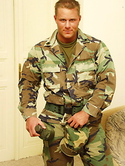 Muscled european soldier stripping