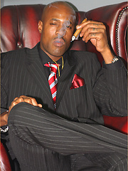 Smoking hot gay black man takes off his suit pants and plays with his cock