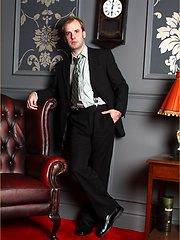 Horny gay guy in a suit wanking his cock