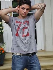 Tattooed stud Jeremy stroking his cock outdoors.